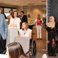 tom continues to speak in microphone with new attendees listening